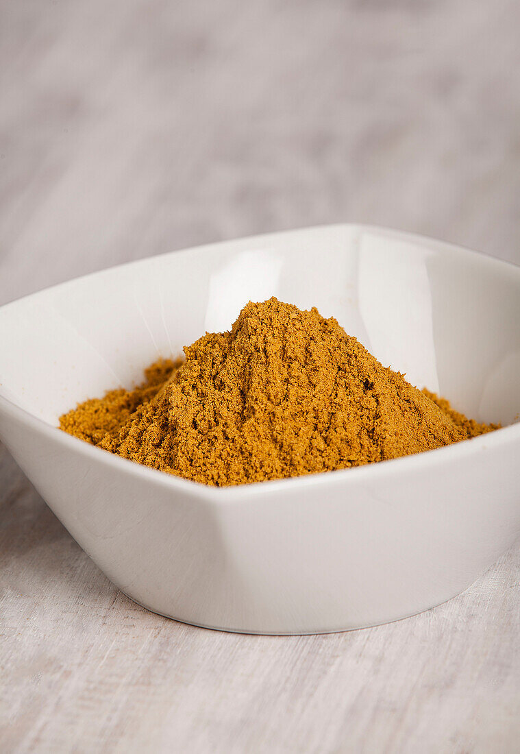 Turmeric powder in a white bowl