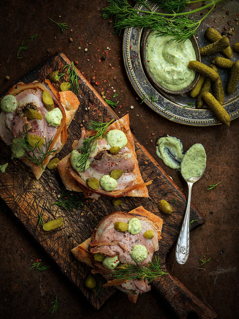 Focaccia with roast pork, gherkins, and dill sauce