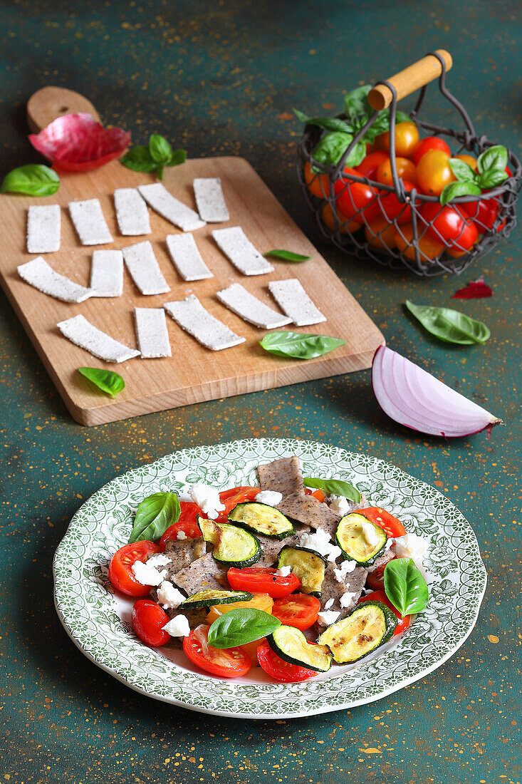 Pizzoccheri (Italian pasta) with zucchini, cherry tomatoes, and feta