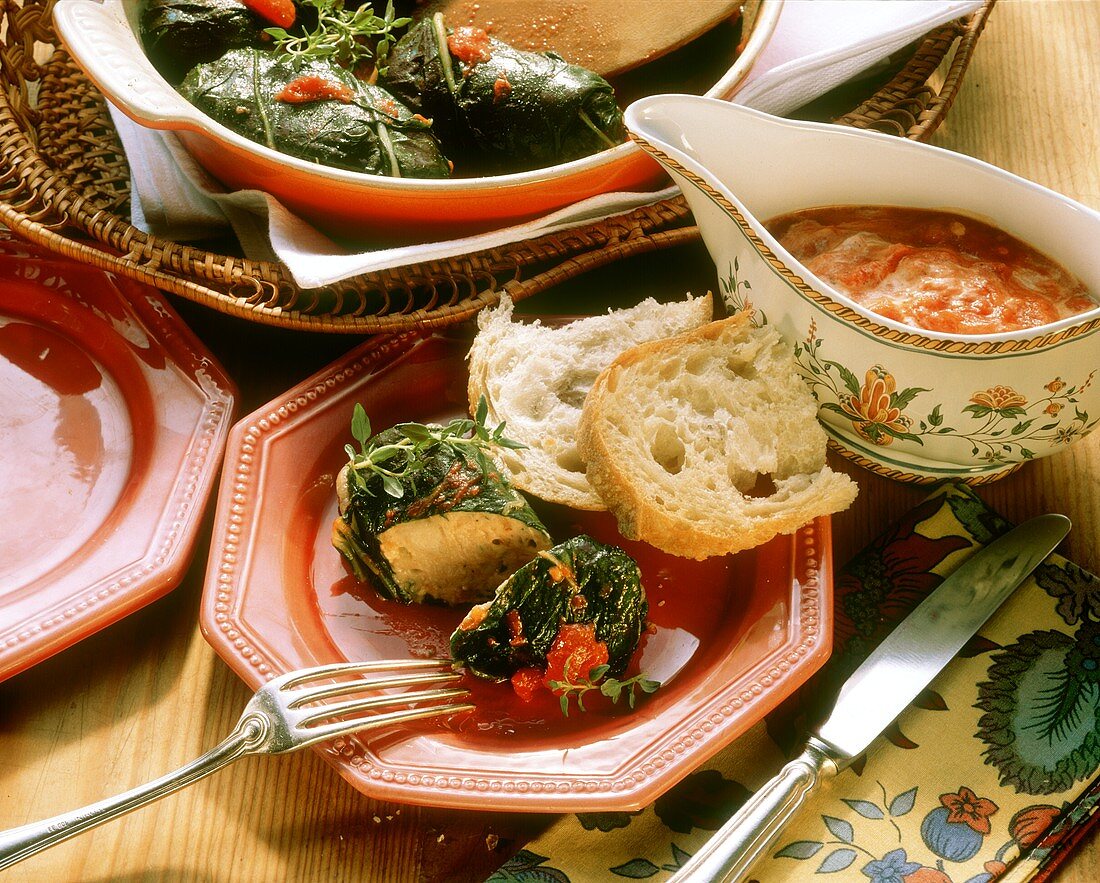 Stuffed chard rolls with tomato sauce on plate