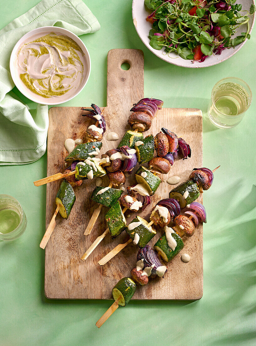 Grilled zucchini and onion mushroom skewers with pistachio pesto yogurt