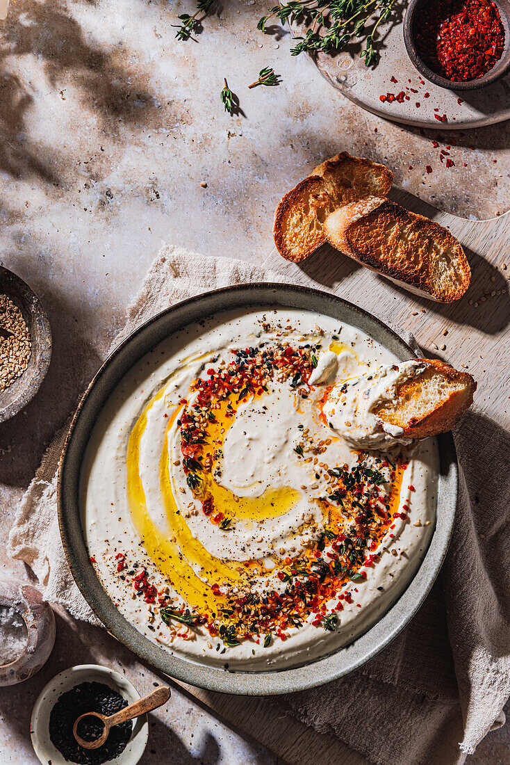 Feta cheese and yogurt dip with topping of olive oil, chili, sesame and thyme
