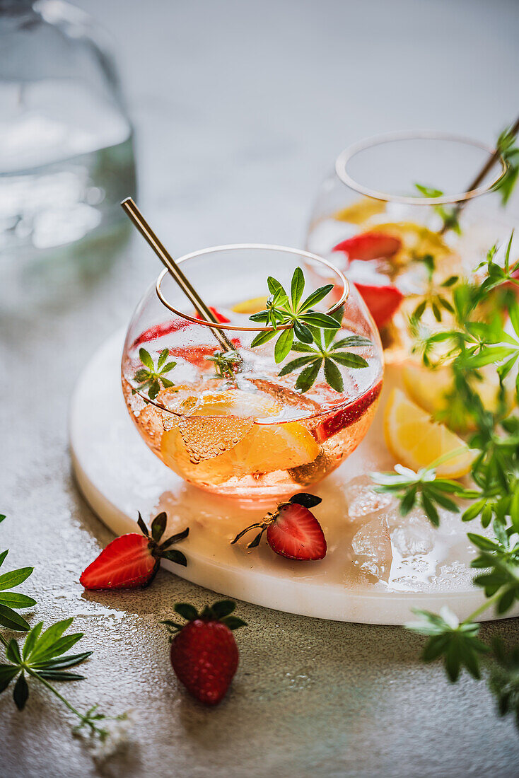 May punch with woodruff, strawberries and lemon
