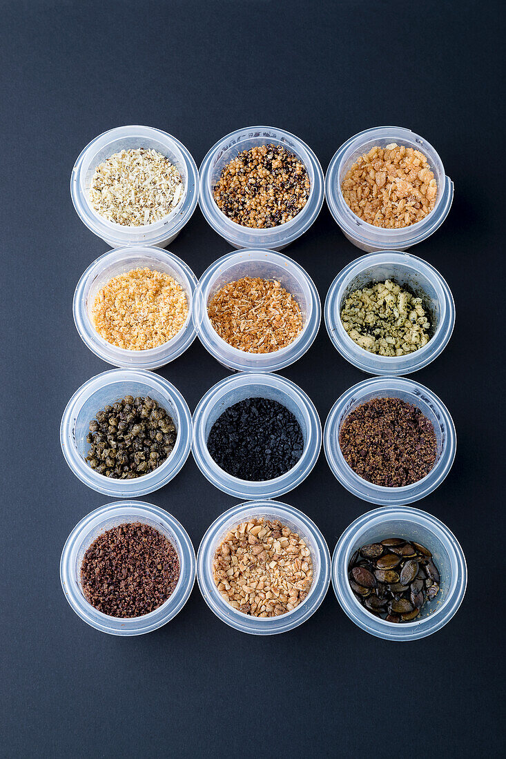 Vegetables, capers, pumpkin seeds, nuts in bowls