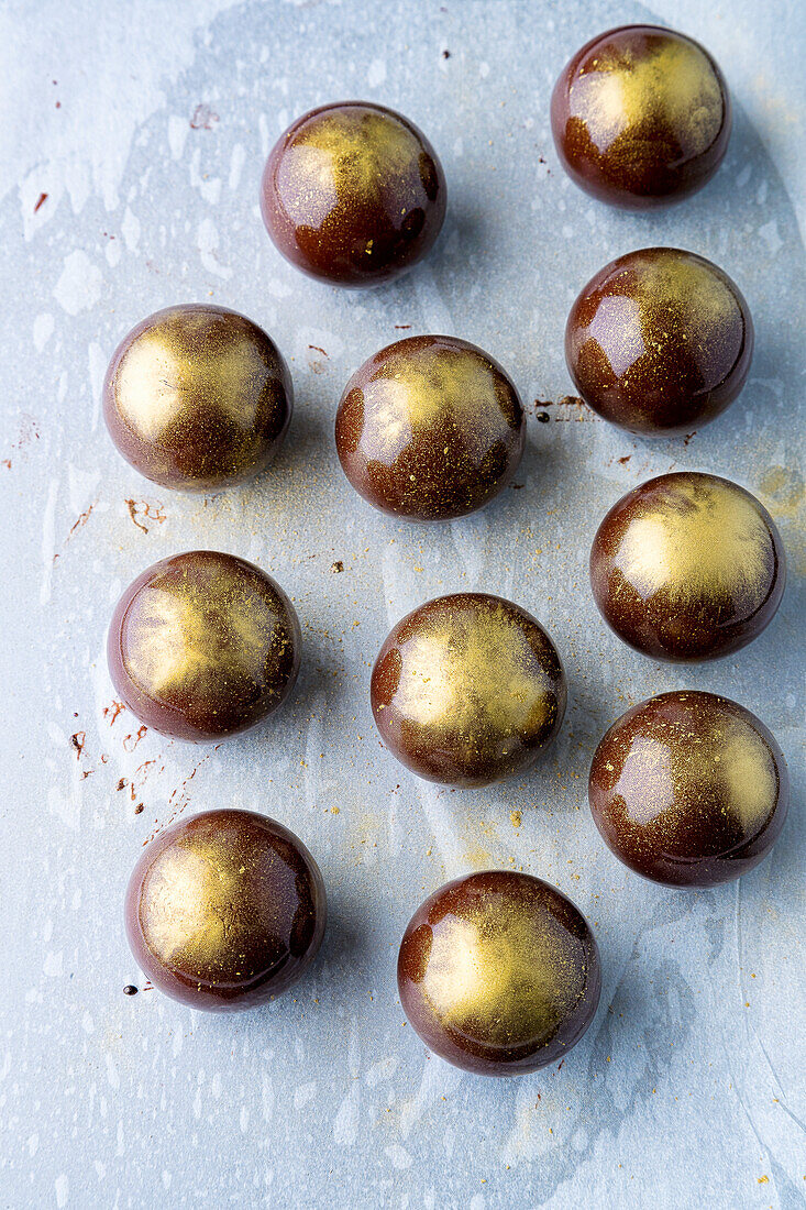 Chocolate balls with gold airbrushing