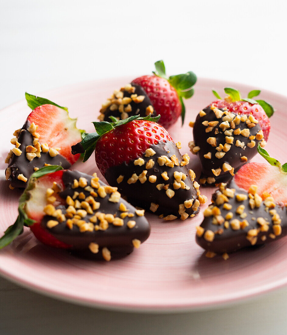 Strawberries with chocolate icing and almond pieces