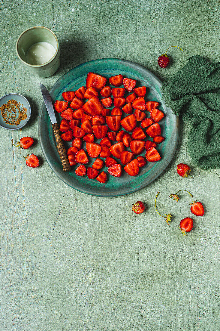 Strawberries, cleaned and halved on a plate