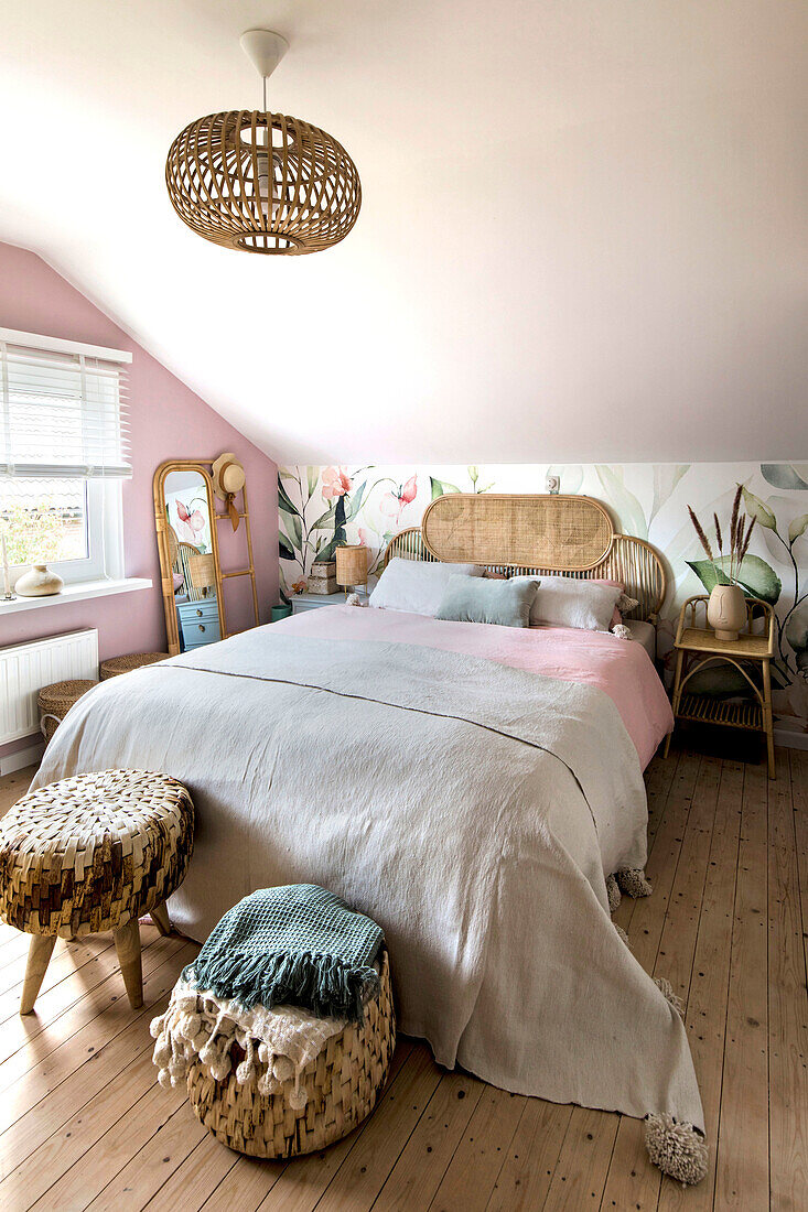 Bedroom with rattan bed and wall paint in pastel colours