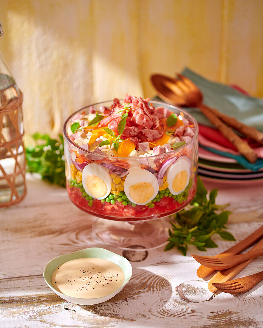 Layered salad with ham and boiled egg