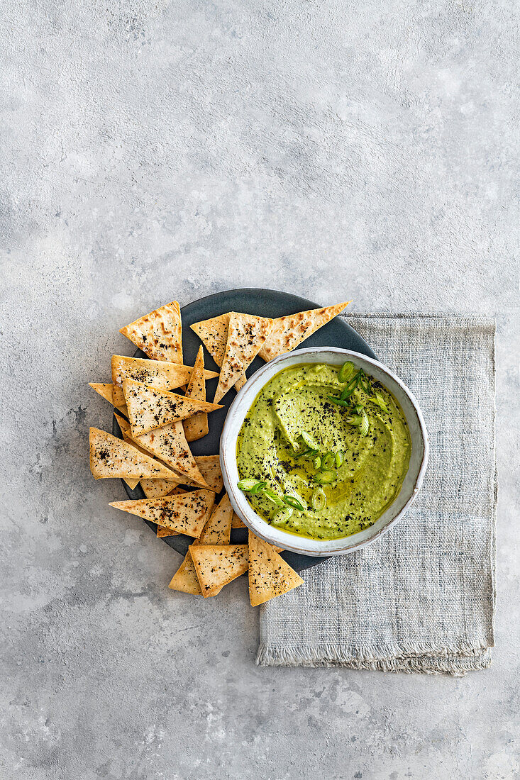 Pea and spring onion hummus with lime and pitta crisps