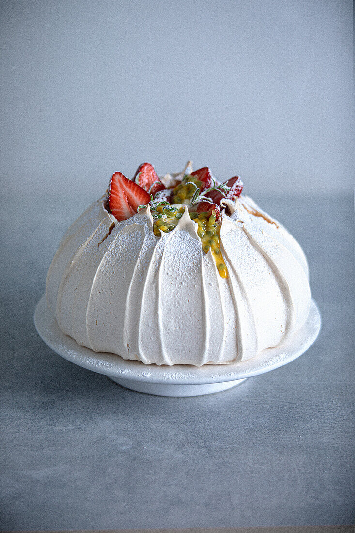 Volcano pavlova with strawberries and passion fruit