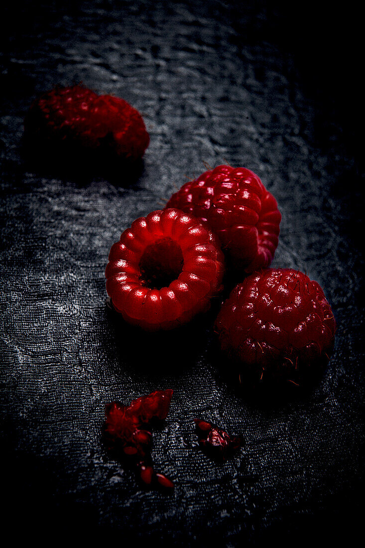 Raspberries on a black surface