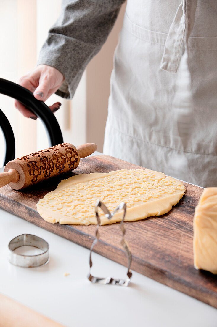 Dough for Easter cookies and rolling pin with Easter motif