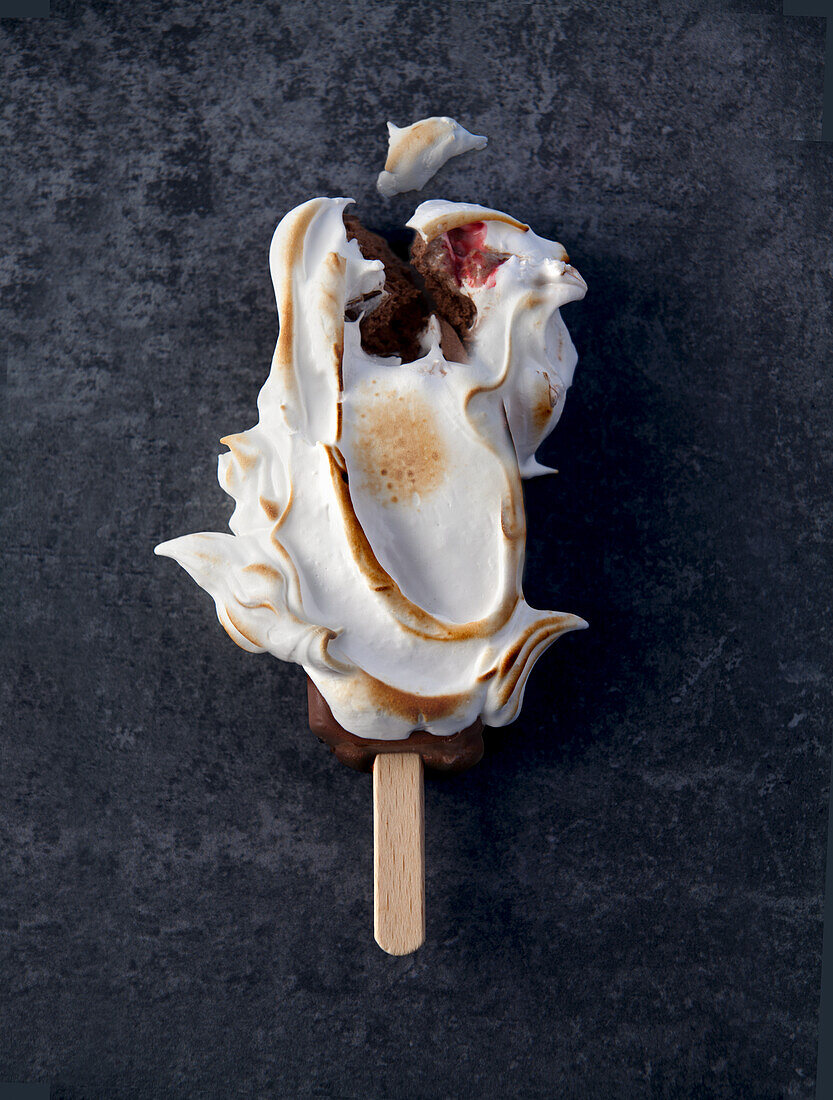 Chocolate ice cream popsicle with toasted meringue