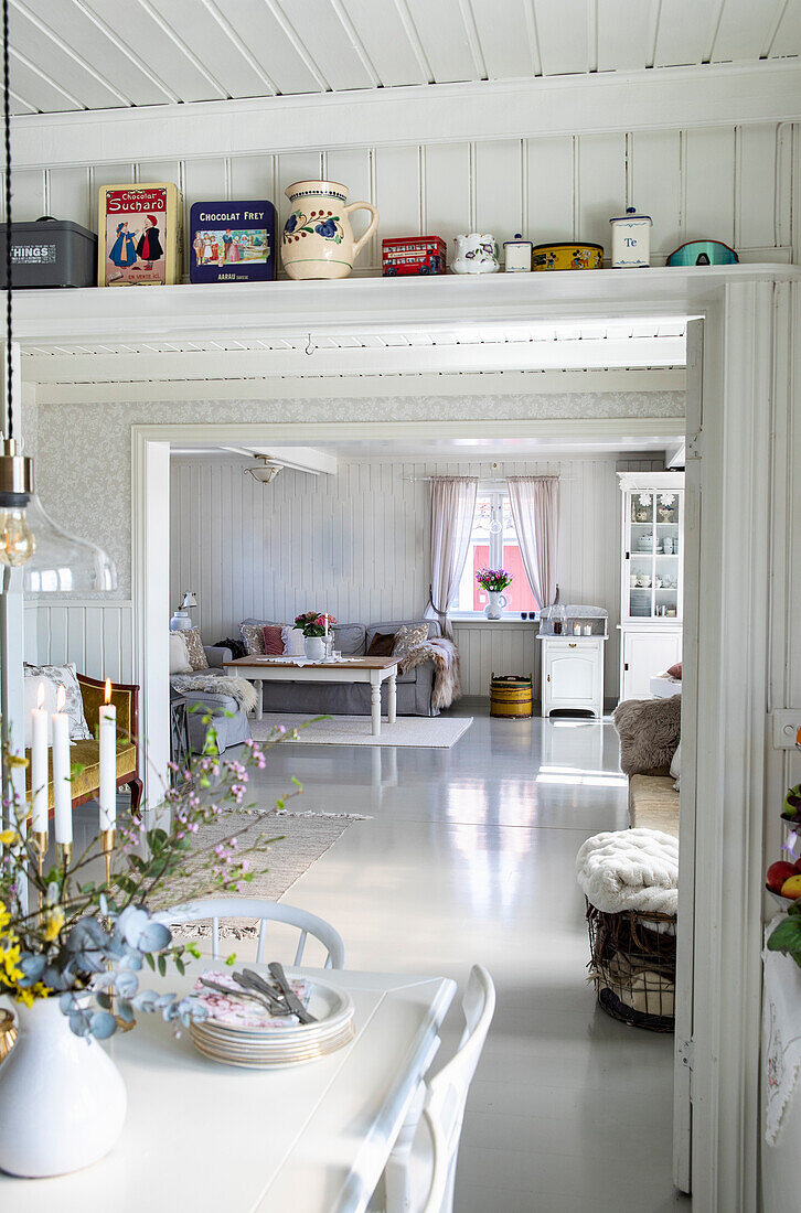 Brightly painted country-style dining room with a view into the living room