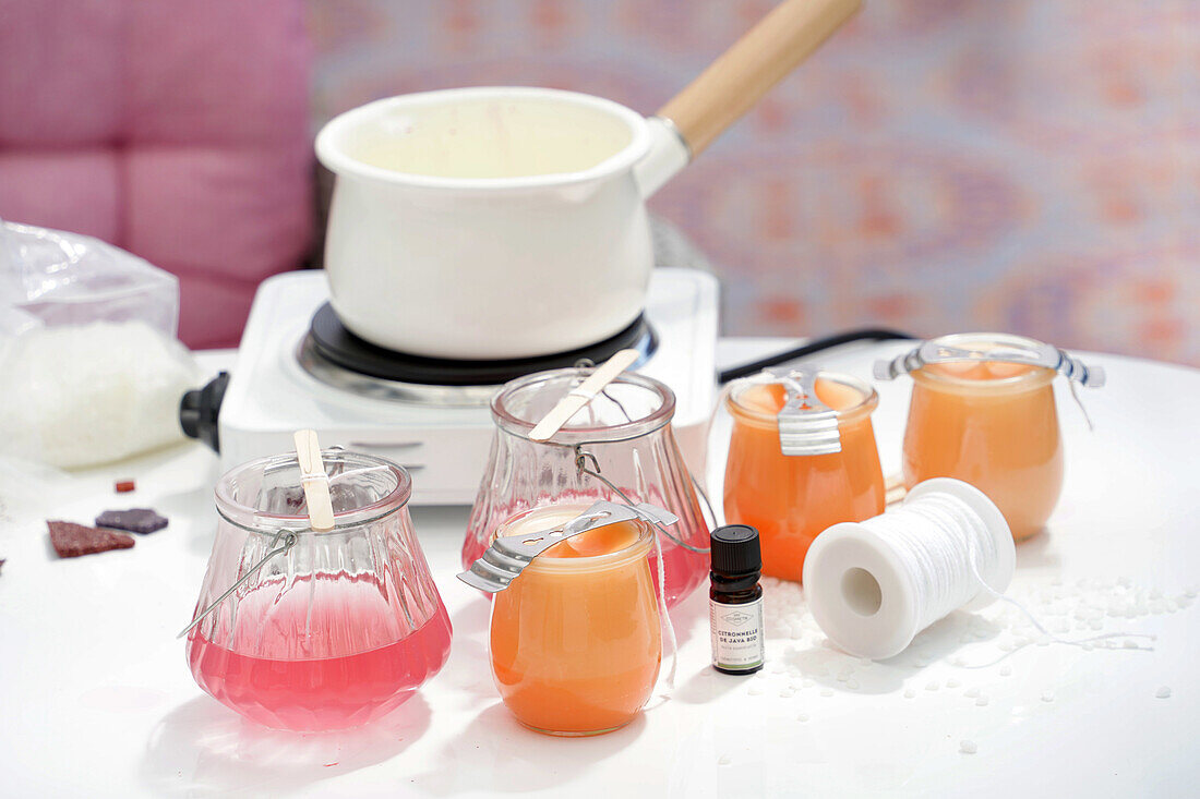 DIY candle making with pink and orange wax in jars