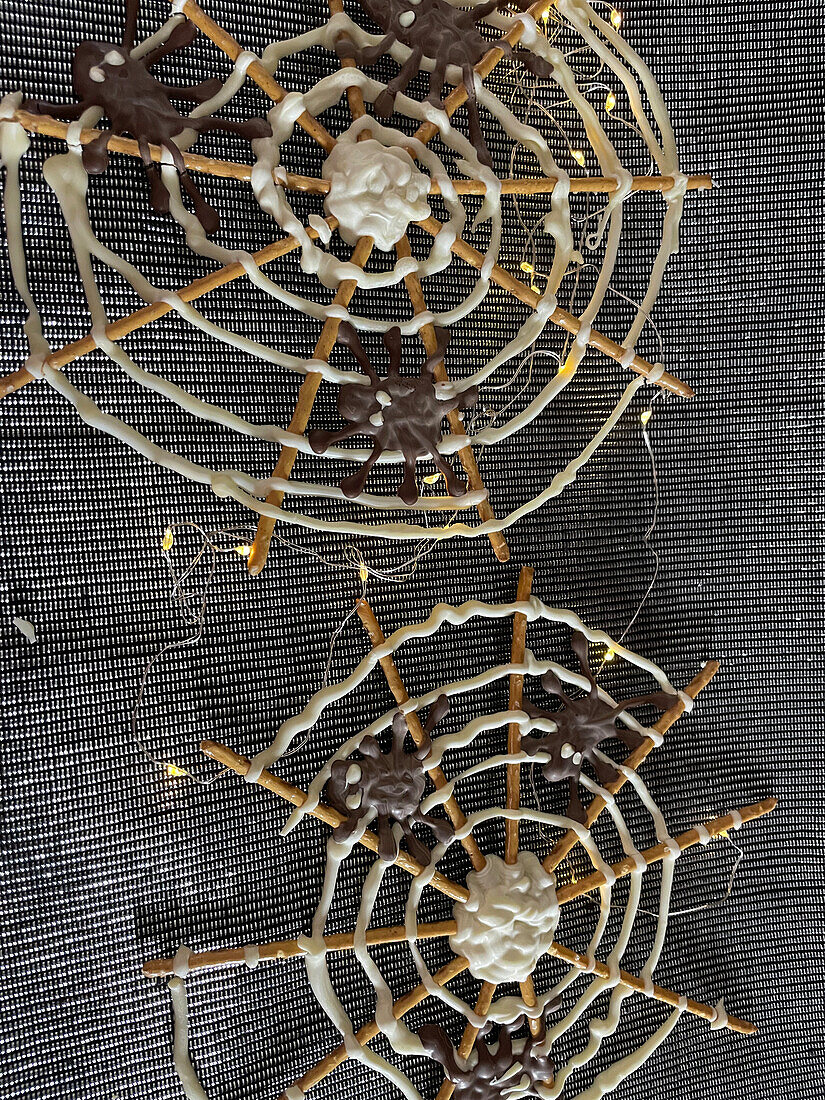 Spider's web made from pretzel sticks and chocolate for Halloween