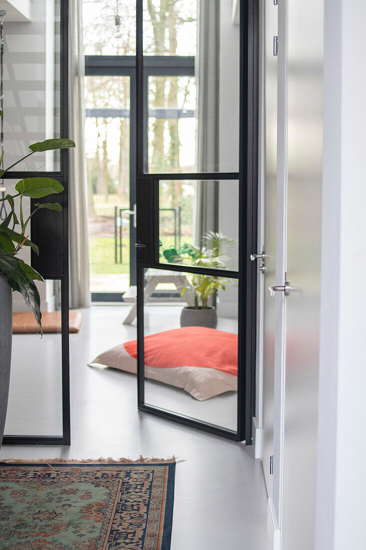 Bright hallway with glass doors and houseplants