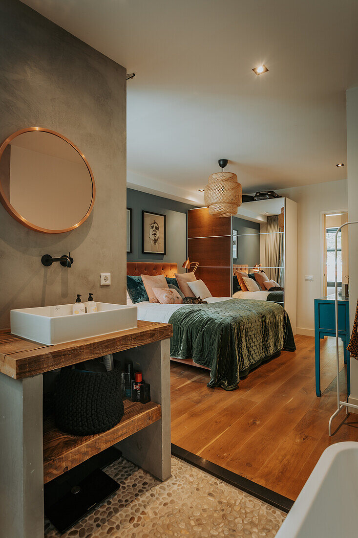 Bedroom with integrated washing area, stone and wooden flooring