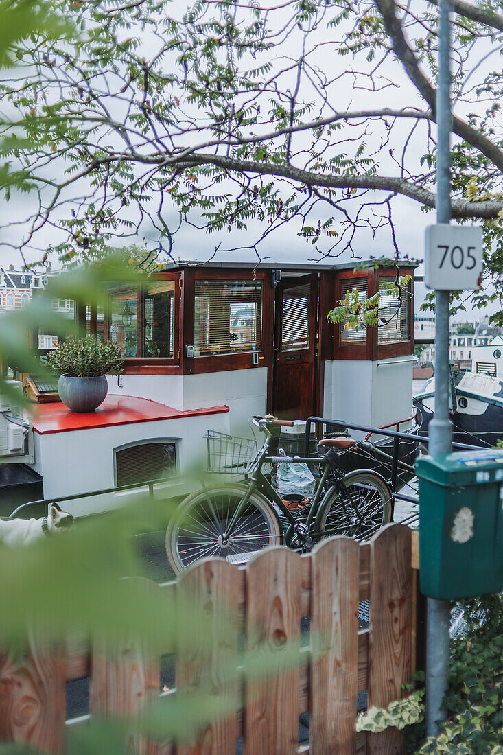 Bicycle parked in front of houseboat