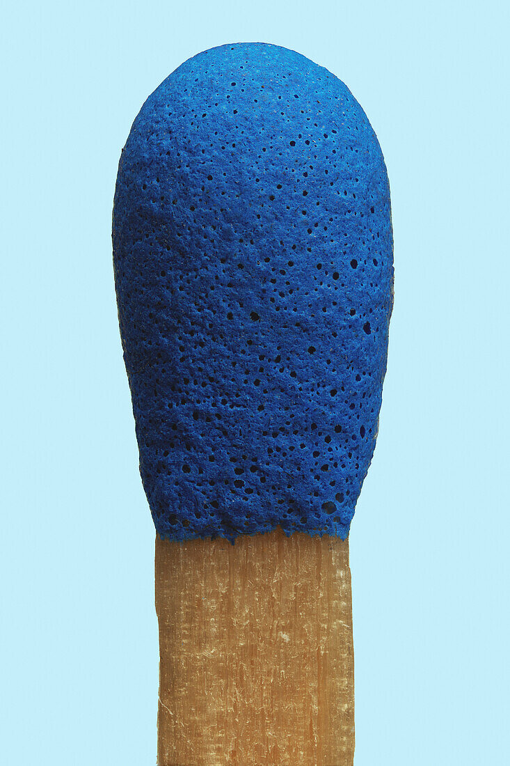 Close up blue matchstick on blue background\n
