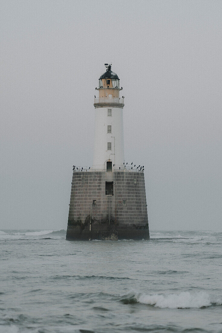 Lighthouse on stormy sea, Rattray, Aberdeenshire, Scotland\n