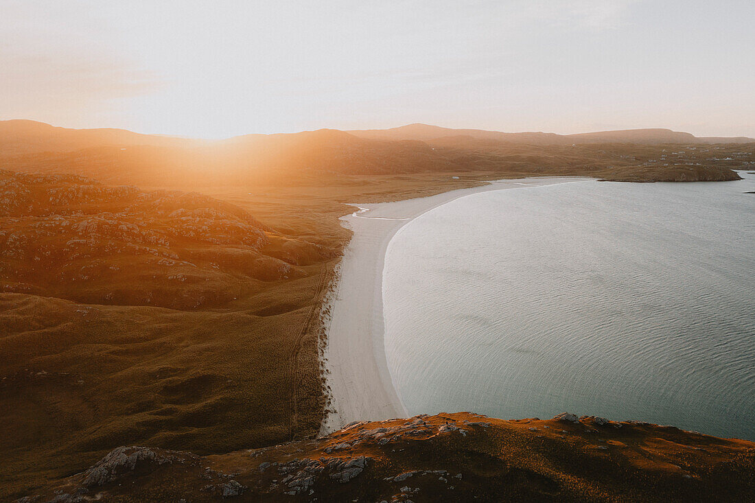 Scenic view idyllic sunset over ocean beach, Isle of Harris, Outer Hebrides, Scotland\n