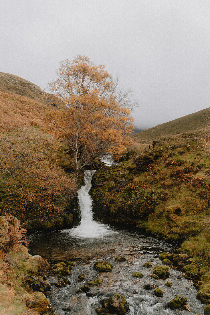 Idyllic waterfall in remote autumn landscape, Assynt, Sutherland, Scotland\n