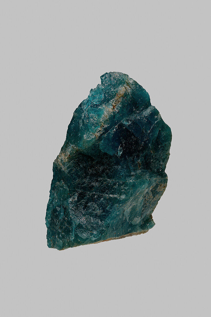Close up green textured Madagascan apatite stone on gray background\n