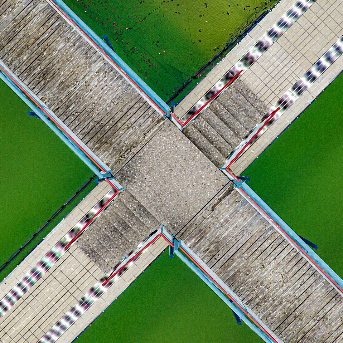 Aerial view intersecting walkways over green salt ponds, Oberndorf am Neckar, Germany\n