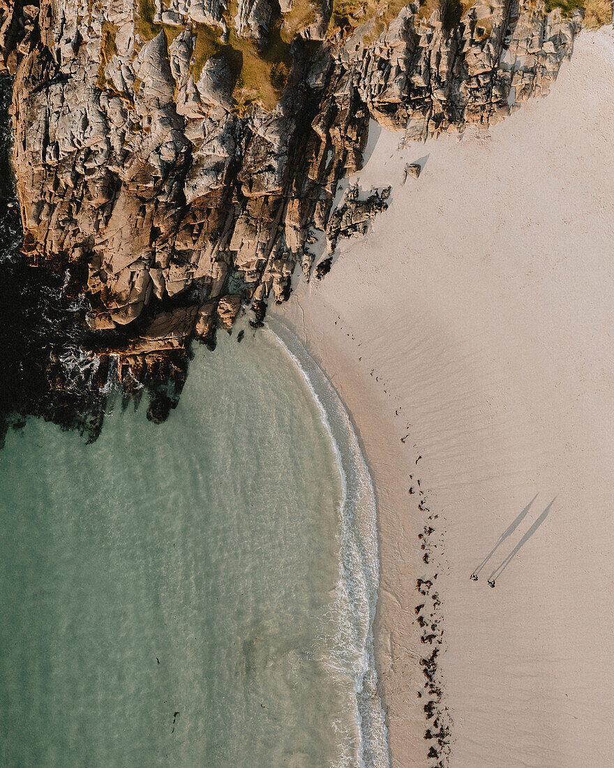 Aerial view from above people on sandy ocean beach, Assynt, Sutherland, Scotland\n