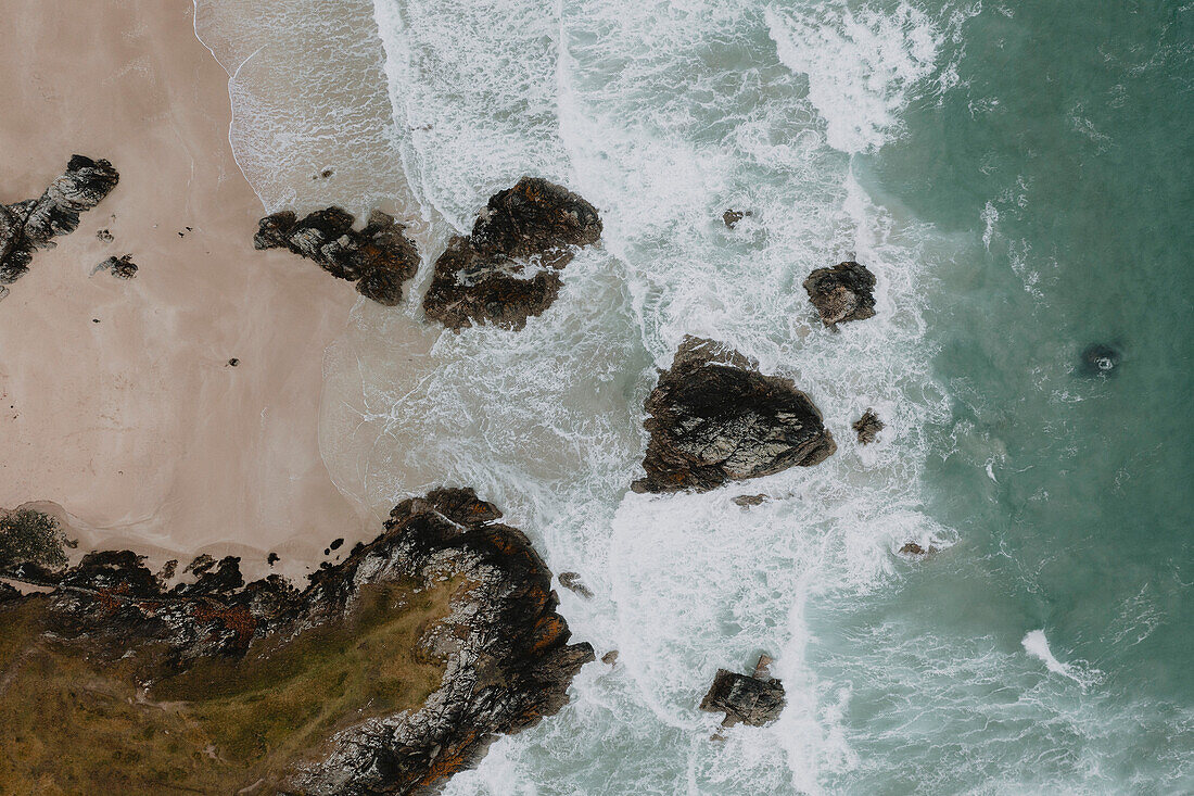 Aerial view from above rocks on ocean beach, Durness, Scottish Highlands, Scotland\n