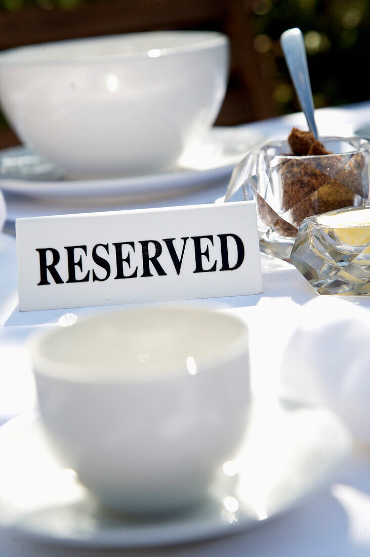 Close up of breakfast table with reserved sign\n