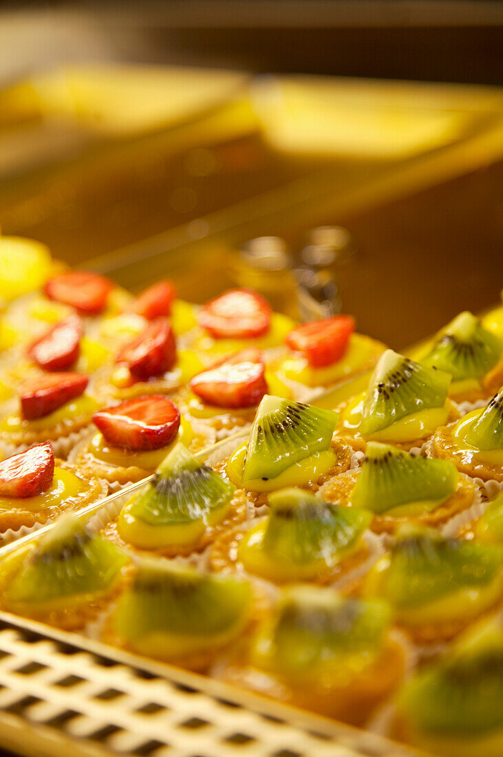 Close up of mini cakes and fruit confection\n