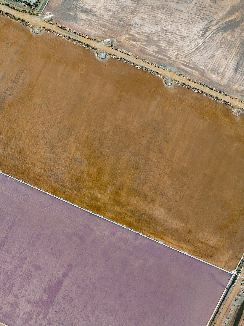 Aerial view brown and purple salt ponds, Majorca, Spain\n