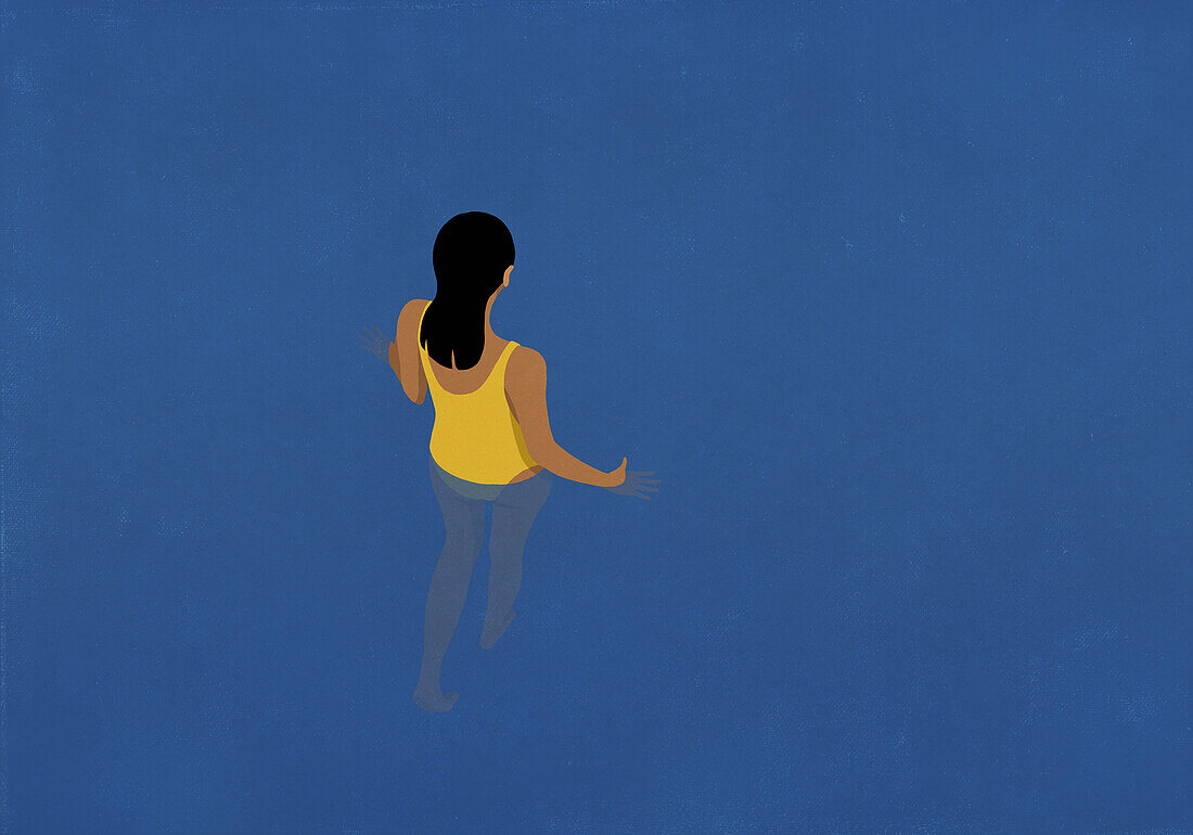 Woman walking into blue water\n