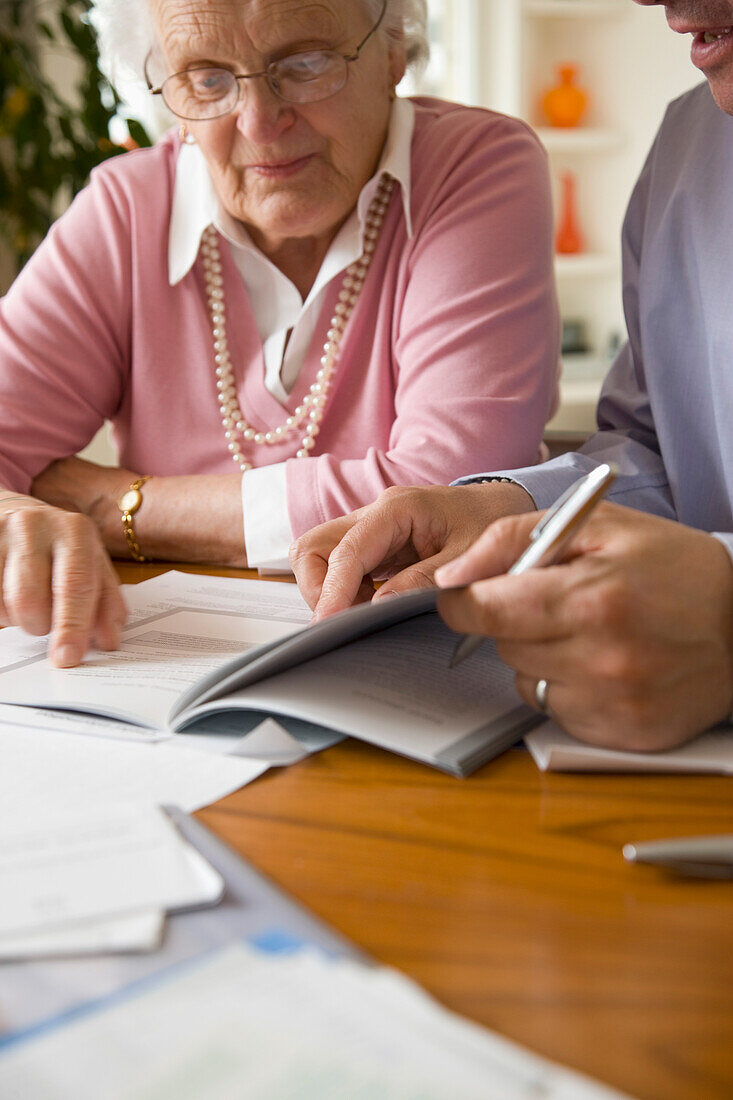 Portrait of a businessman and woman sitting and looking at documents\n