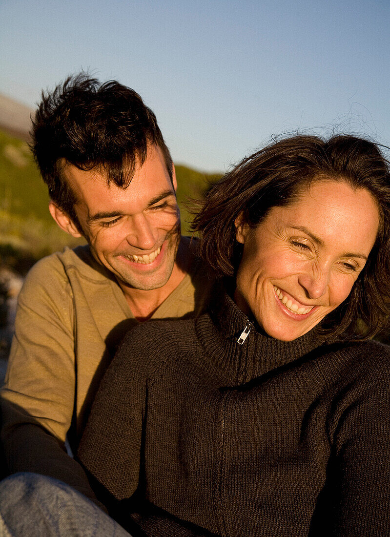 Portrait of couple embracing and laughing\n