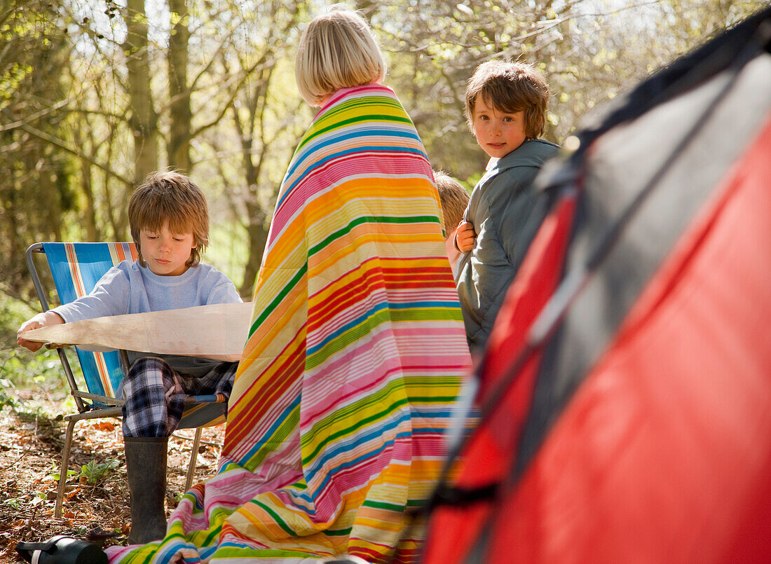 Children at campsite looking at map\n