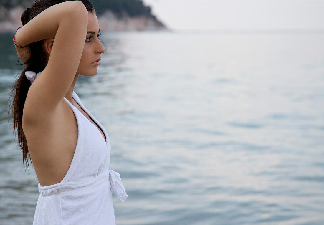 Portrait of young woman standing on beach\n