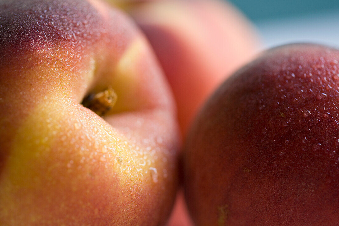 Extreme close up of three peaches\n