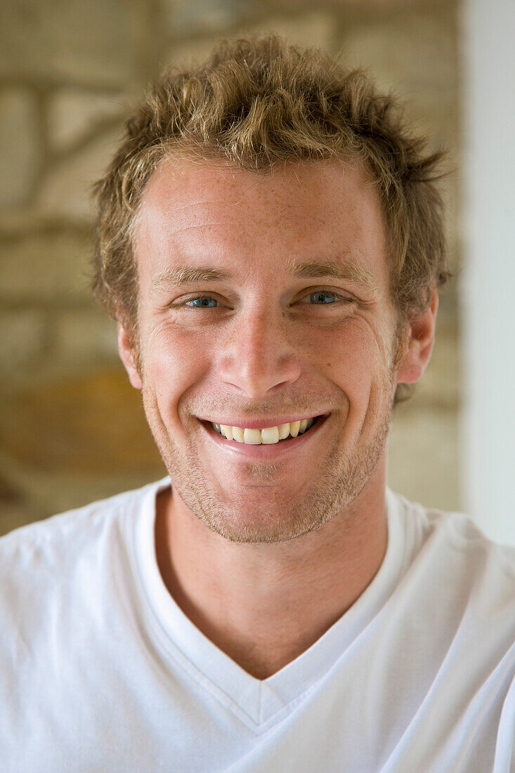 Close up of a young man smiling\n