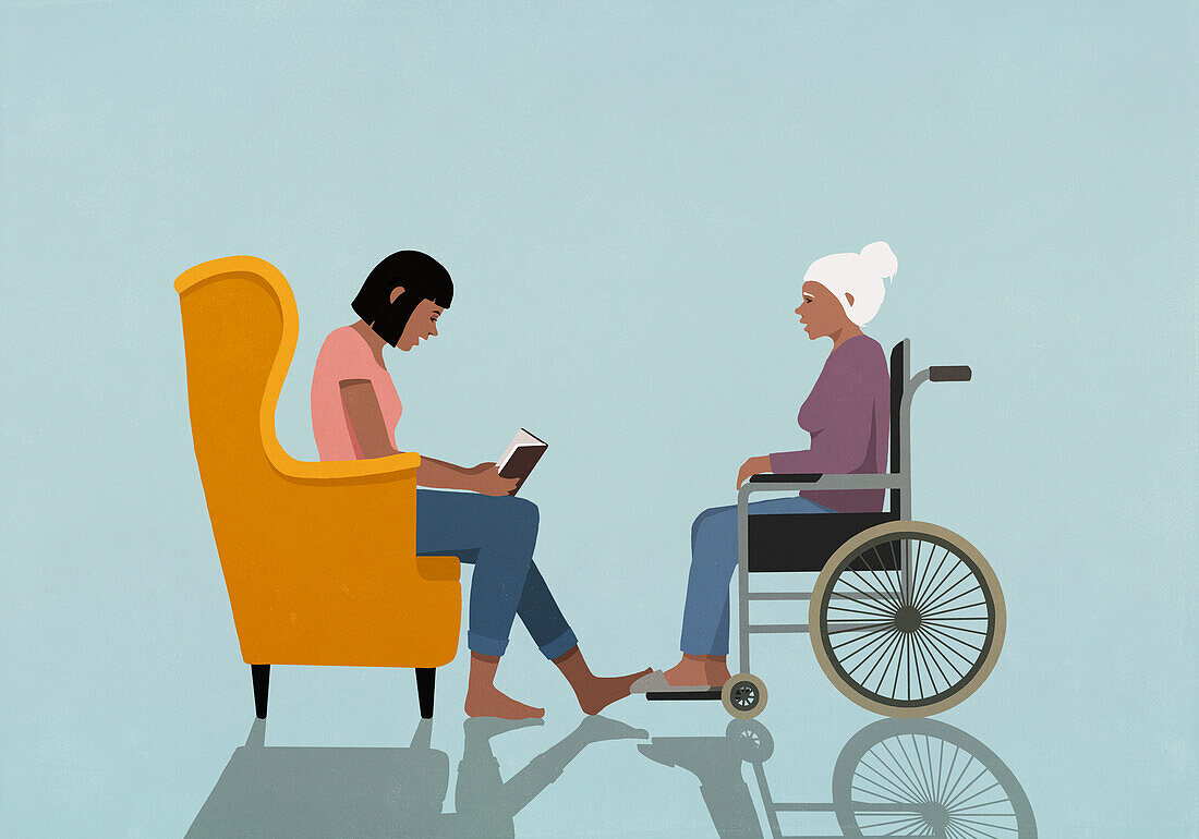 Woman in armchair reading book to senior woman in wheelchair\n