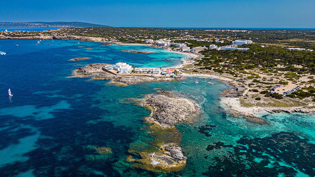 Aerial of the turquoise waters and white sand beach of the Pujols beach, Formentera, Balearic Islands, Spain, Mediterranean, Europe\n