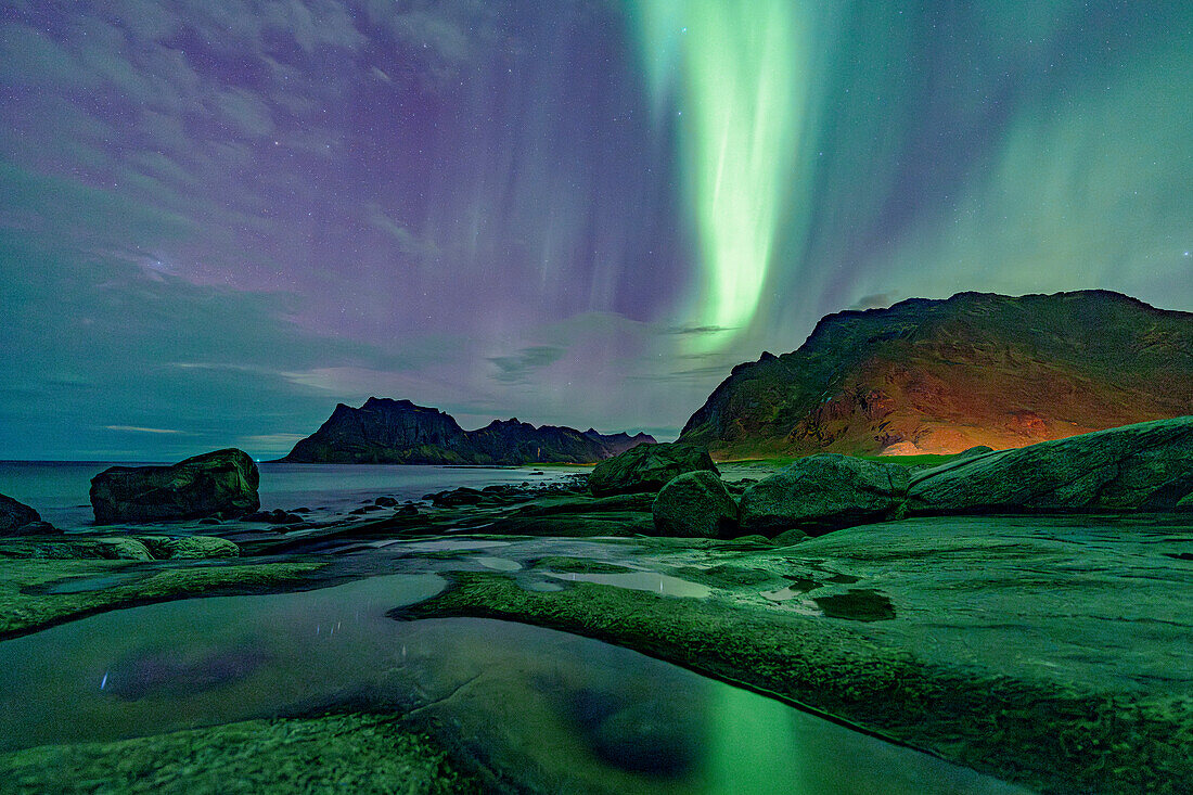 Uttakleiv beach under the multicolored sky during the Aurora Borealis (Northern Lights), Vestvagoy, Lofoten Islands, Nordland, Norway, Scandinavia, Europe\n