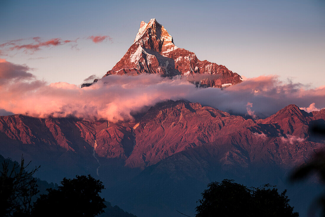 Anapurna peak over the clouds deep in the Himalayas at sunrise, Australian Camp, Nepal, Asia\n