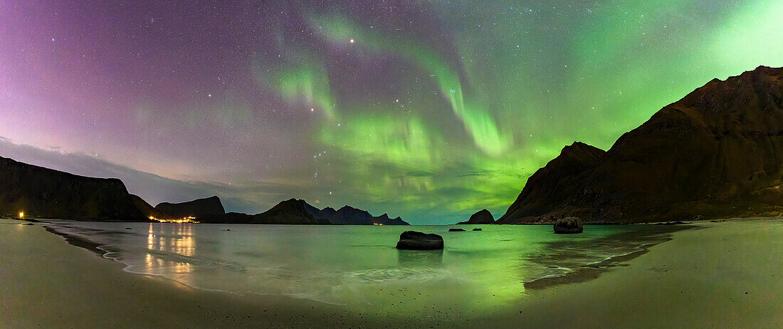Panoramic of the frozen Haukland beach under a multicolored sky with Aurora Borealis (Northern Lights), Lofoten Islands, Nordland, Norway, Scandinavia, Europe\n