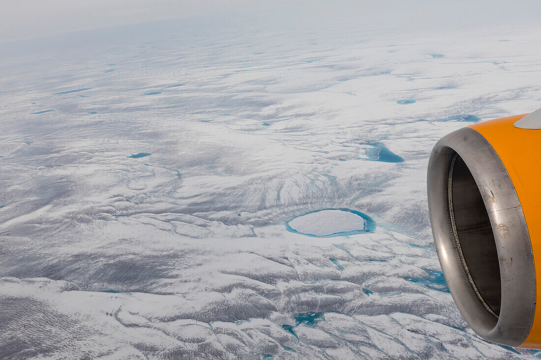 A commercial flight over the Greenland Ice Sheet flying into Kangerlussuaq, Qeqqata municipality, Western Greenland, Polar Regions\n