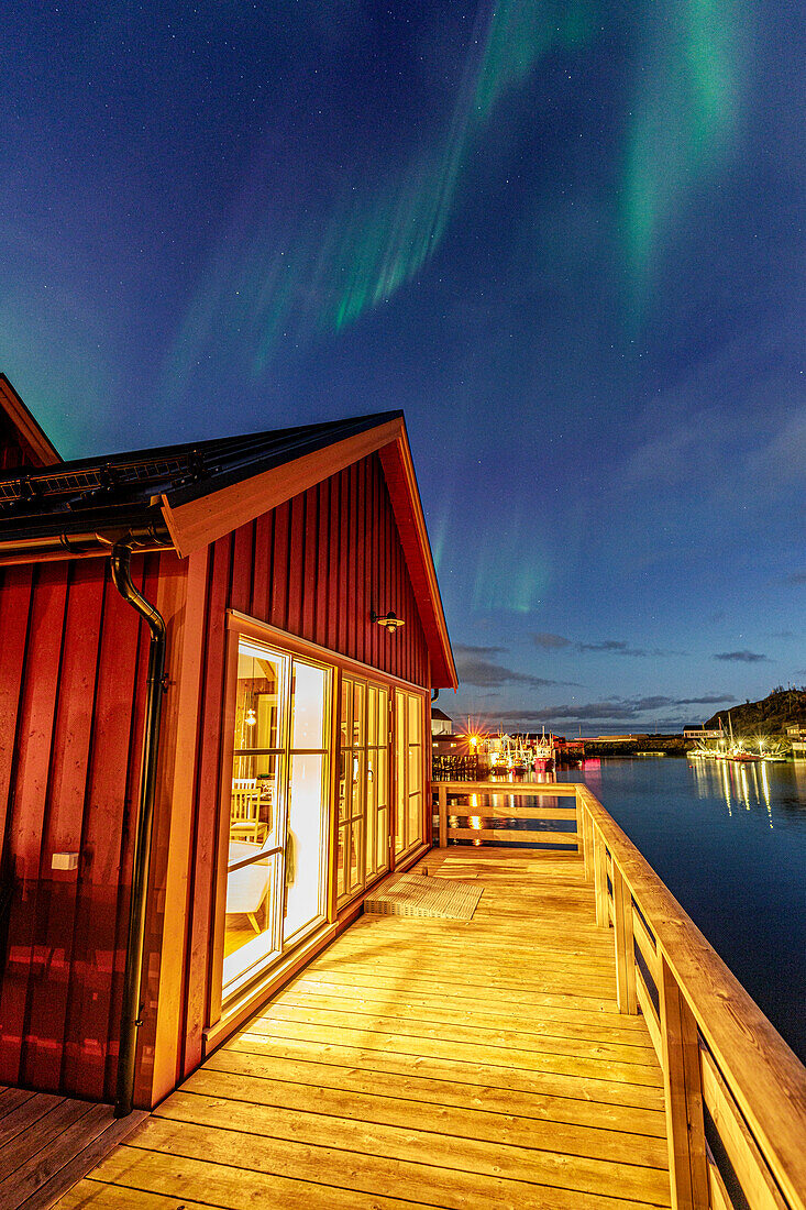 Illuminated red cabin under the Northern Lights, Hamnoy, Reine, Lofoten Islands, Nordland, Norway, Scandinavia, Europe\n