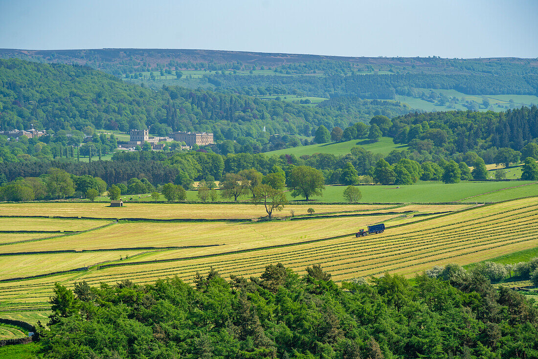 View of farmland and Chatsworth House in spring, Derbyshire Dales, Derbyshire, England, United Kingdom, Europe\n